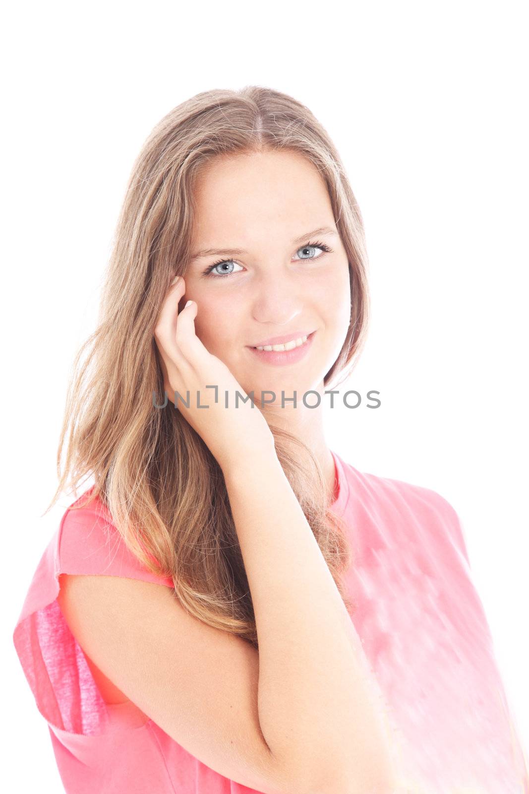 Attractive young girl with a friendly smile having a conversation on her mobile isolated on white Attractive young girl with a friendly smile having a conversation on her mobile 