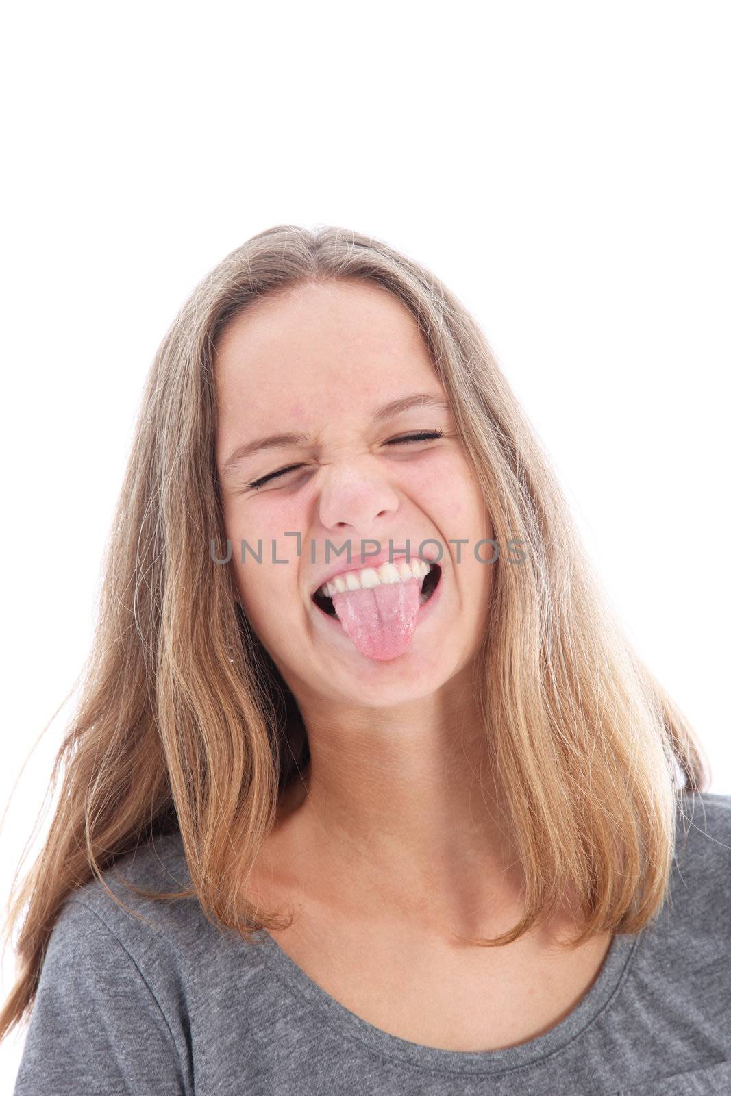 Playful girl sticking out her tongue in provocative mischief or because she has a horrible taste in her mouth 