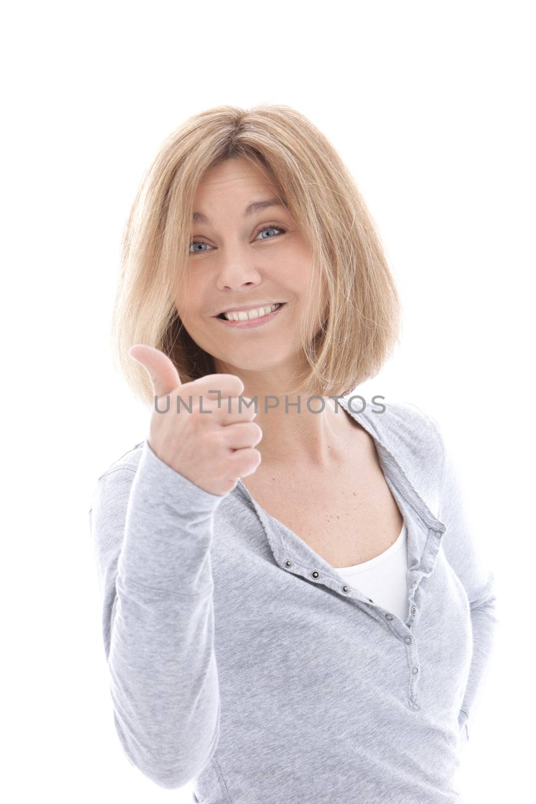 Happy casual blonde woman giving a thumbs up gesture of approval and success as she smiles at the viewer, upper body portrait isolated on white
