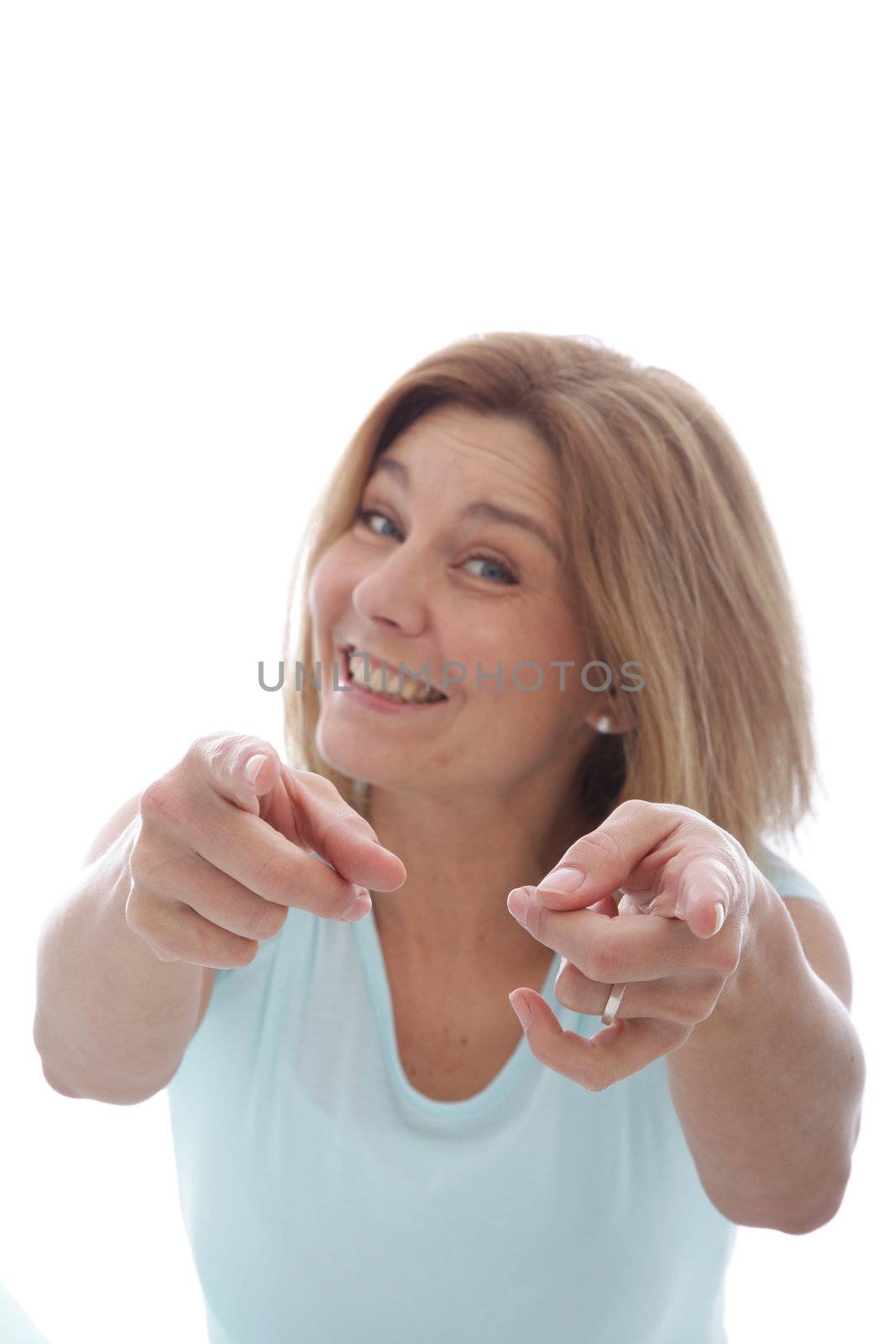 Vivacious woman with a lovely playful smile pointing at the camera with both hands, isolated on white