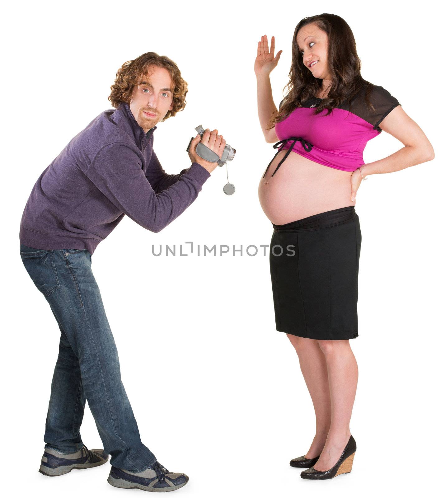Man with video camera in front of pregnant female