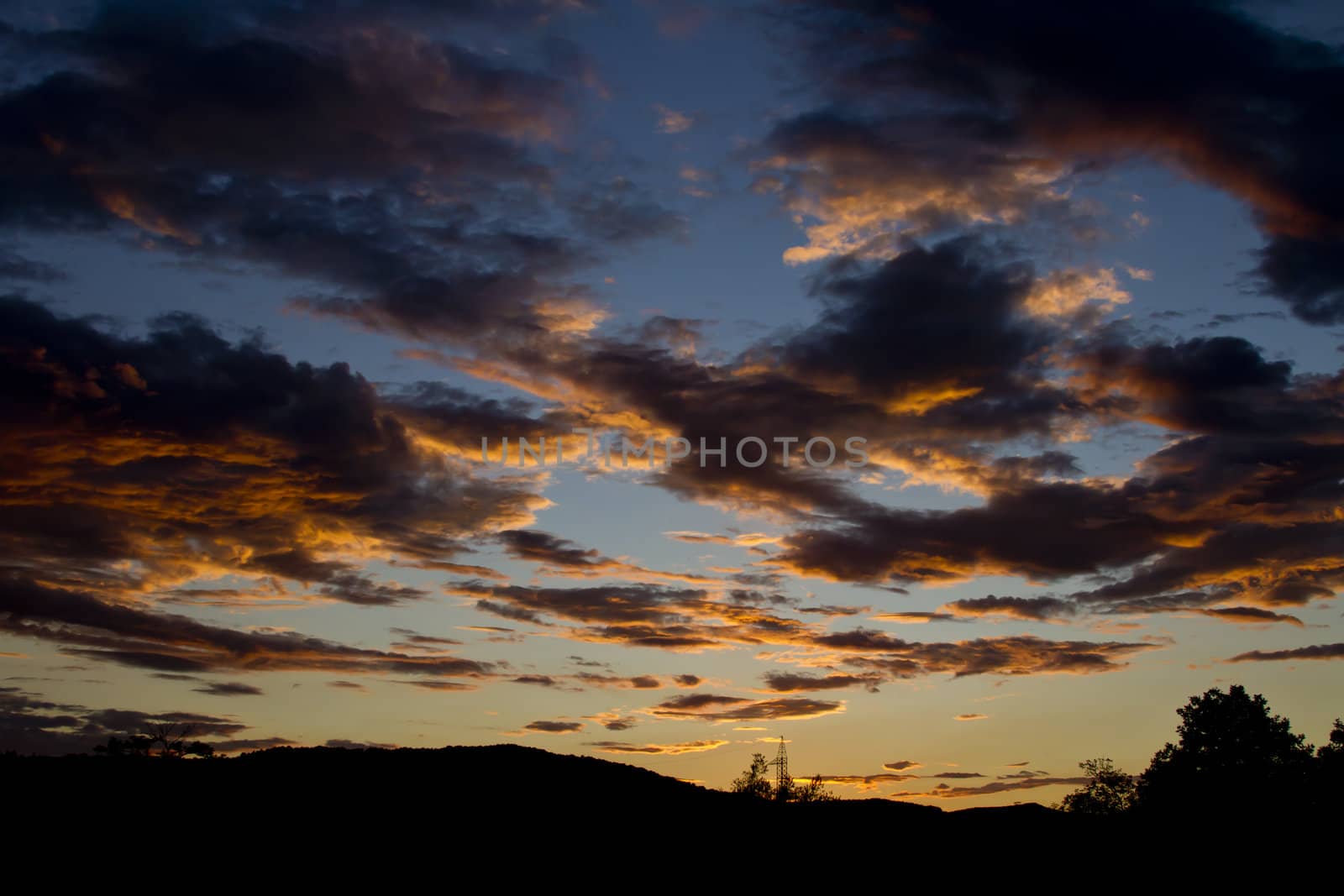 Cloudy sky during sunset in orange and blue