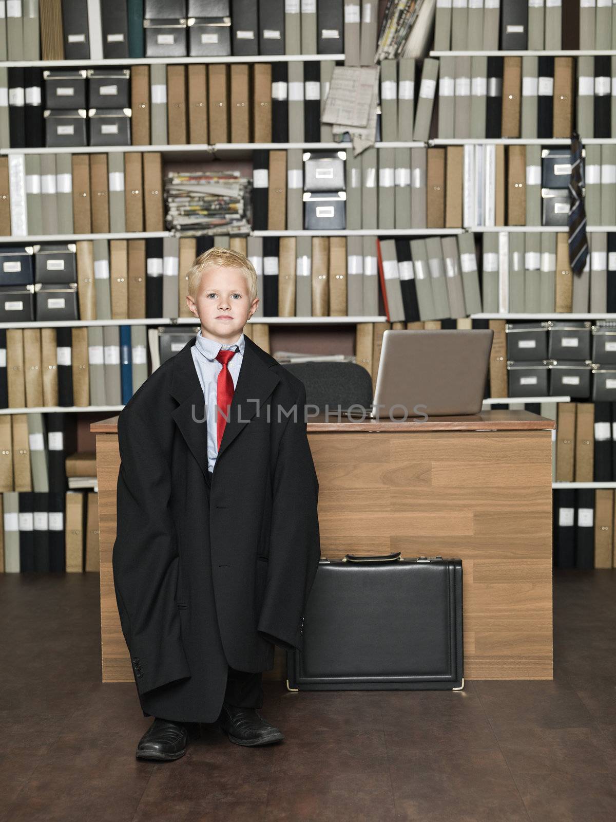 Young Businessman wearing oversized clothes in the office