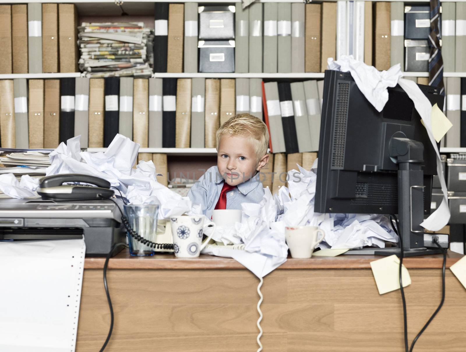 Young business man in a messy office