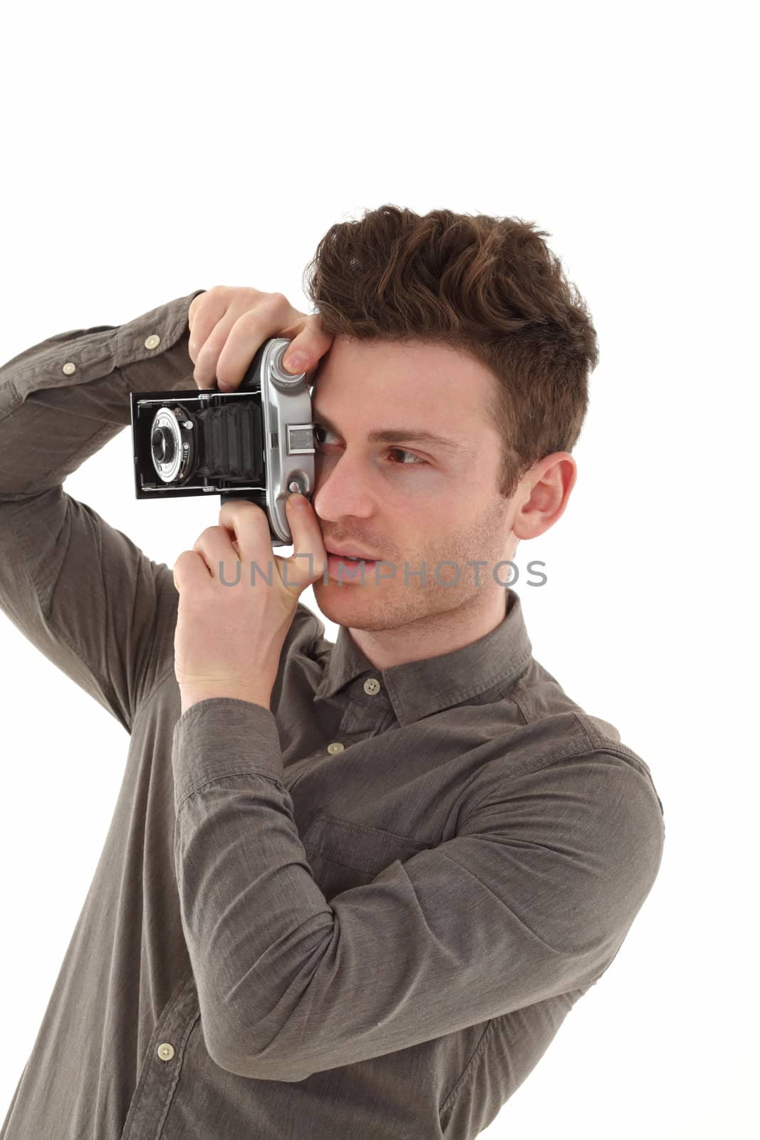 A young adult male on white background with an old film camera