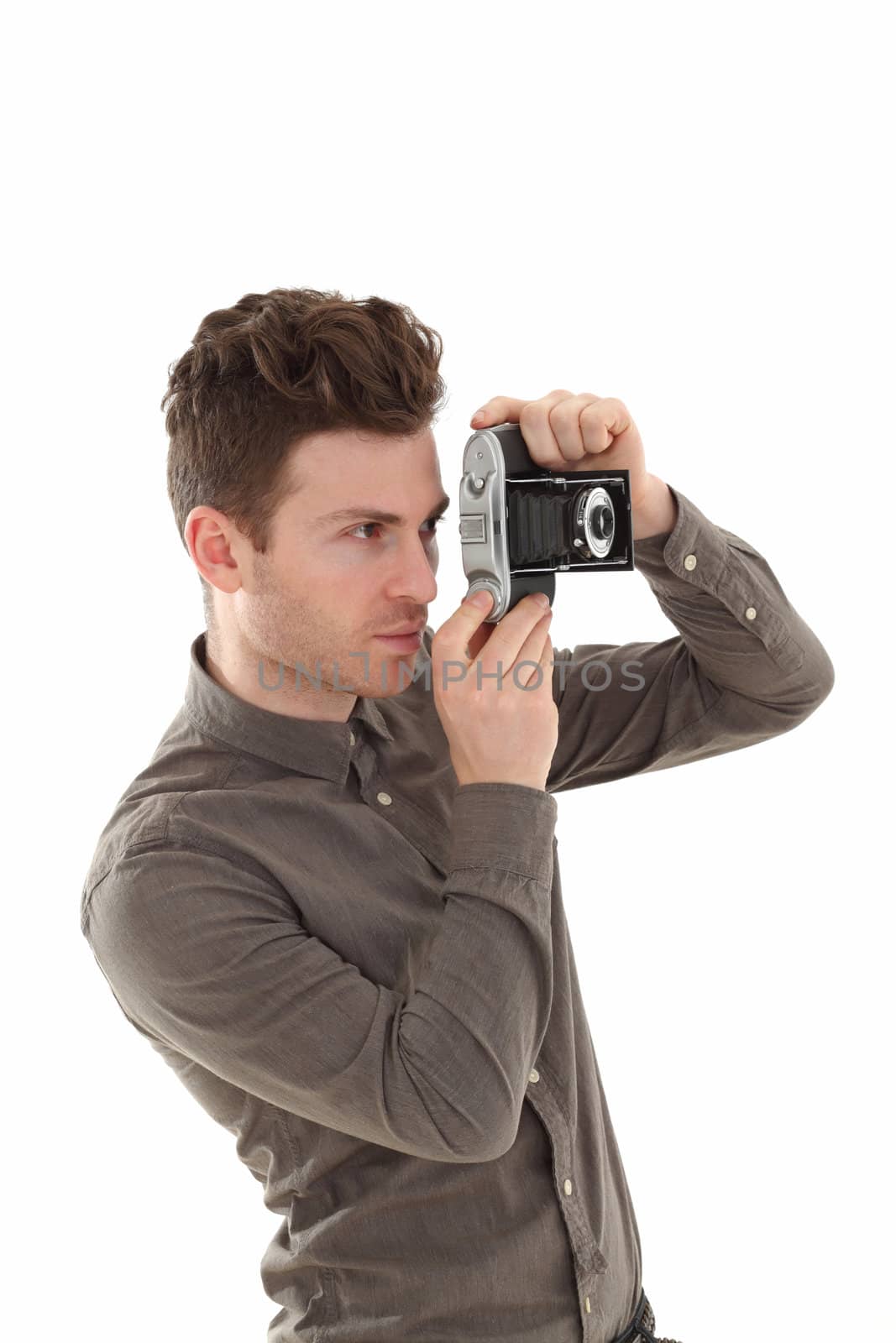 A young adult male on white background with an old film camera