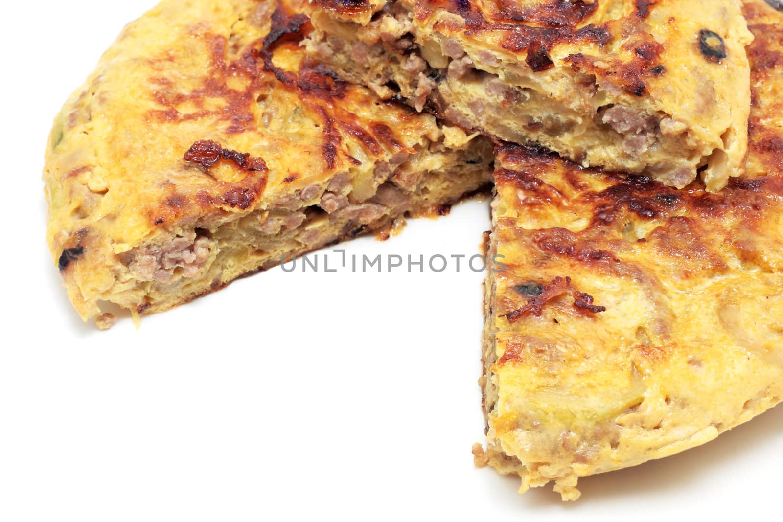spanish omelet of minced meat zucchini and onion on a white background
