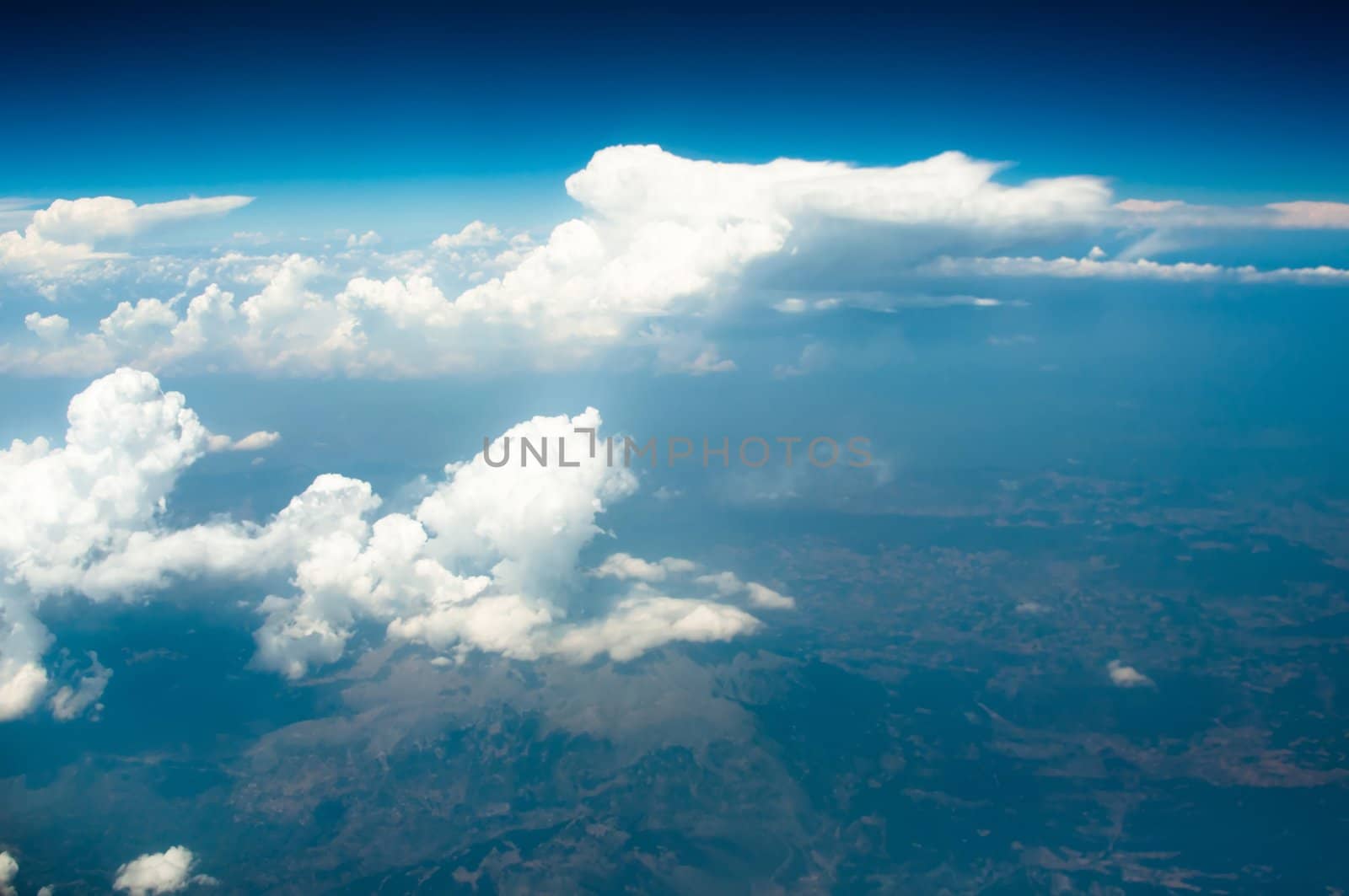 Image of blue sky with white clouds above main land of Greece