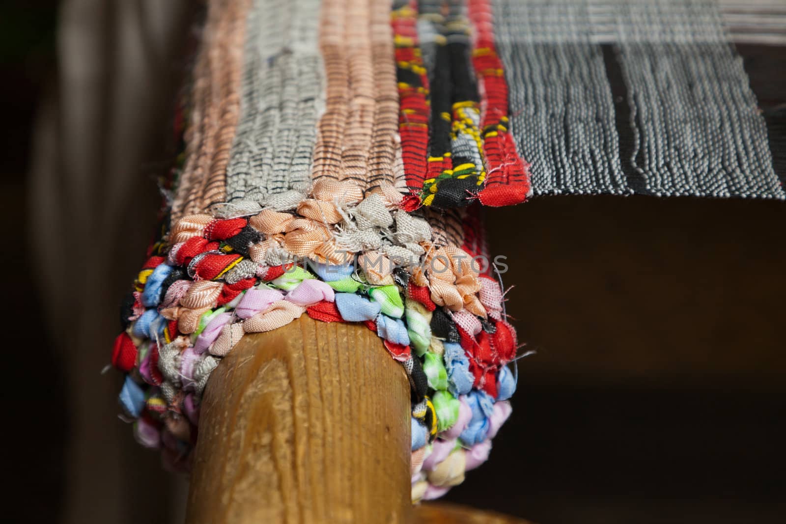 Old wooden loom in weaving - side view. Illuminated by soft light overhead. Close-up