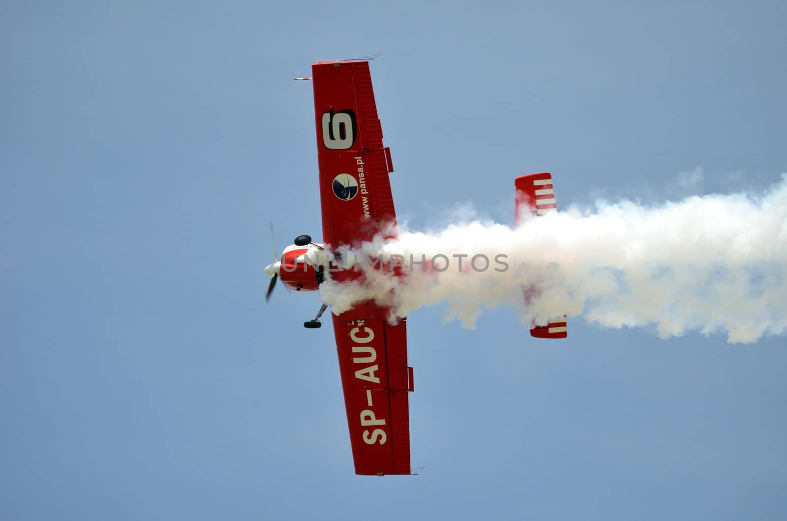 SZYMANOW, POLAND - AUGUST 25: Pilot Tadeusz Kolaszewski performs acrobatic show in plane Zlin-50 LS on August 25, 2012 in Szymanow.