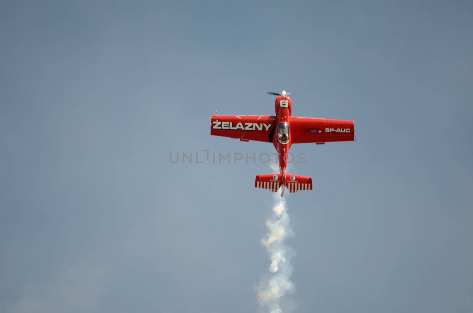 SZYMANOW, POLAND - AUGUST 25: Pilot Tadeusz Kolaszewski performs acrobatic show in plane Zlin-50 LS on August 25, 2012 in Szymanow.