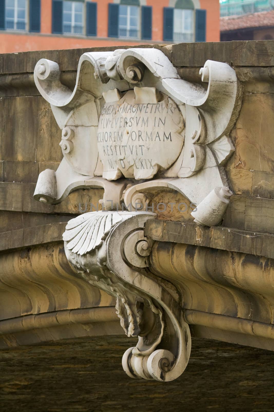 Ornate stone building shield / cartouche on a bridge over the Arno River in Florence, Italy near the Ponte Vecchio Florence