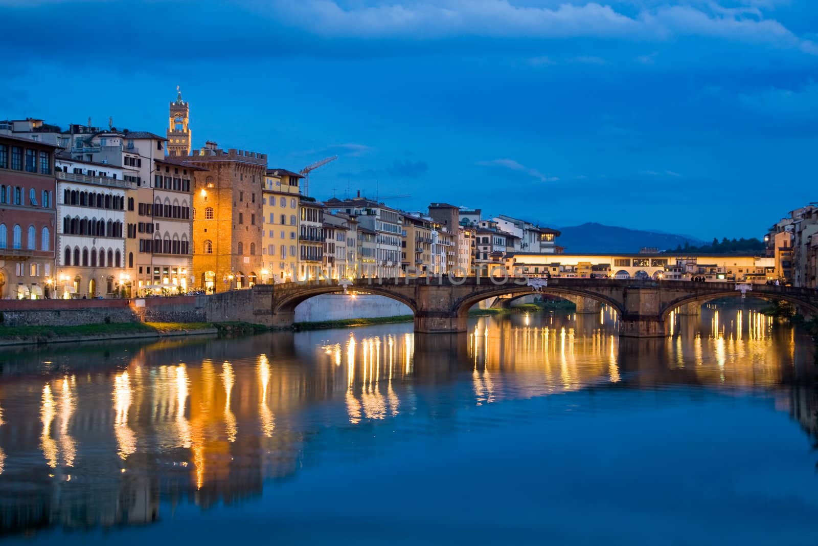 Ancient buildings and old bridge reflecting in River Arno in Florence, Italy
