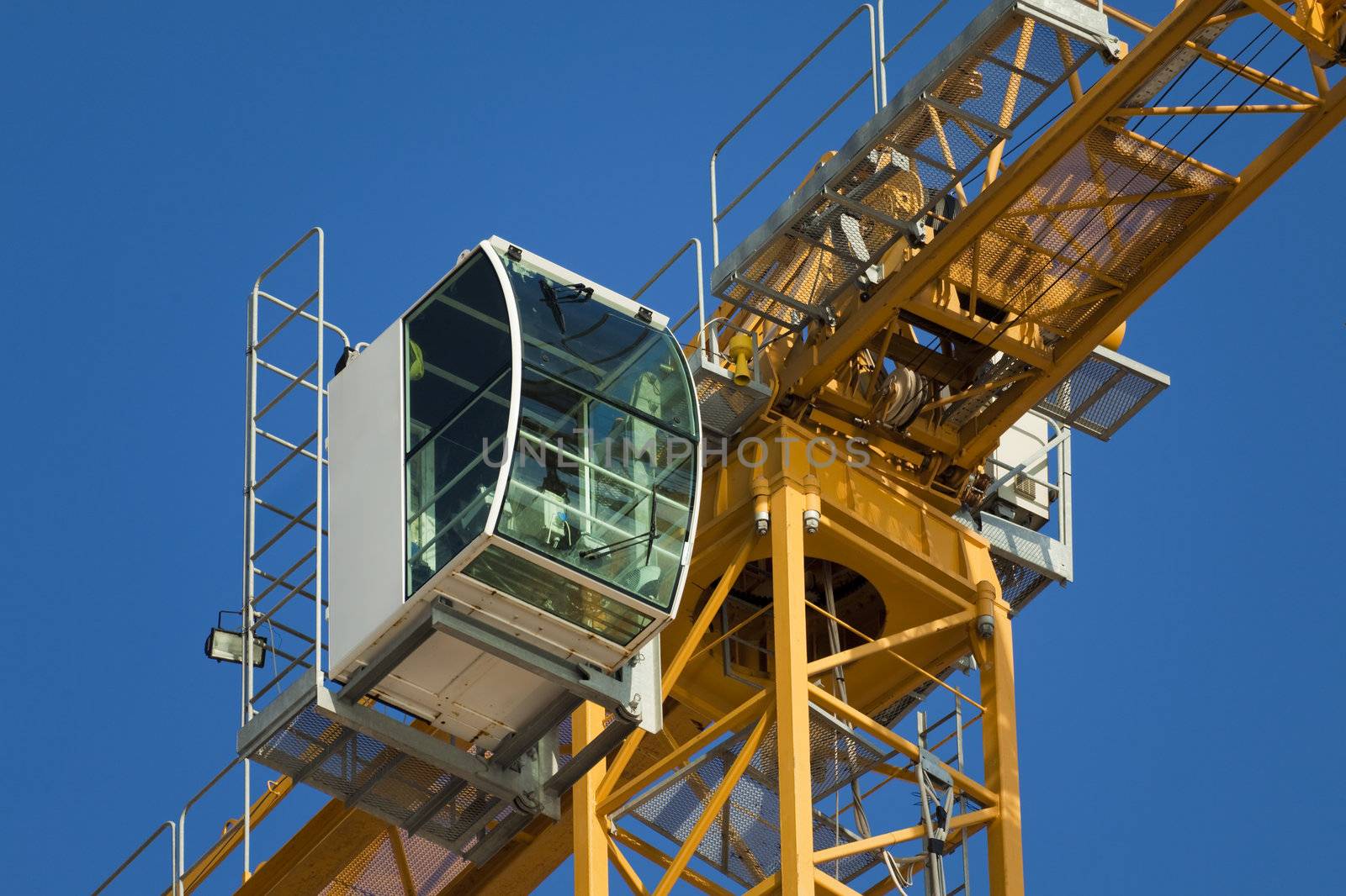 Cab modern construction crane on a background of blue sky