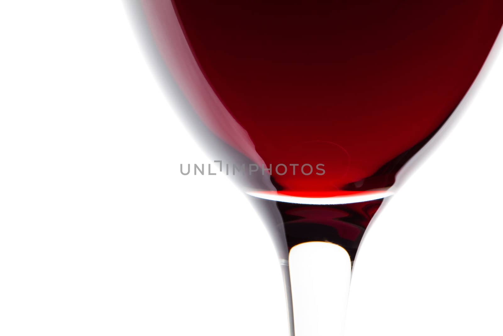 A glass of red wine on white. Detail by Antartis