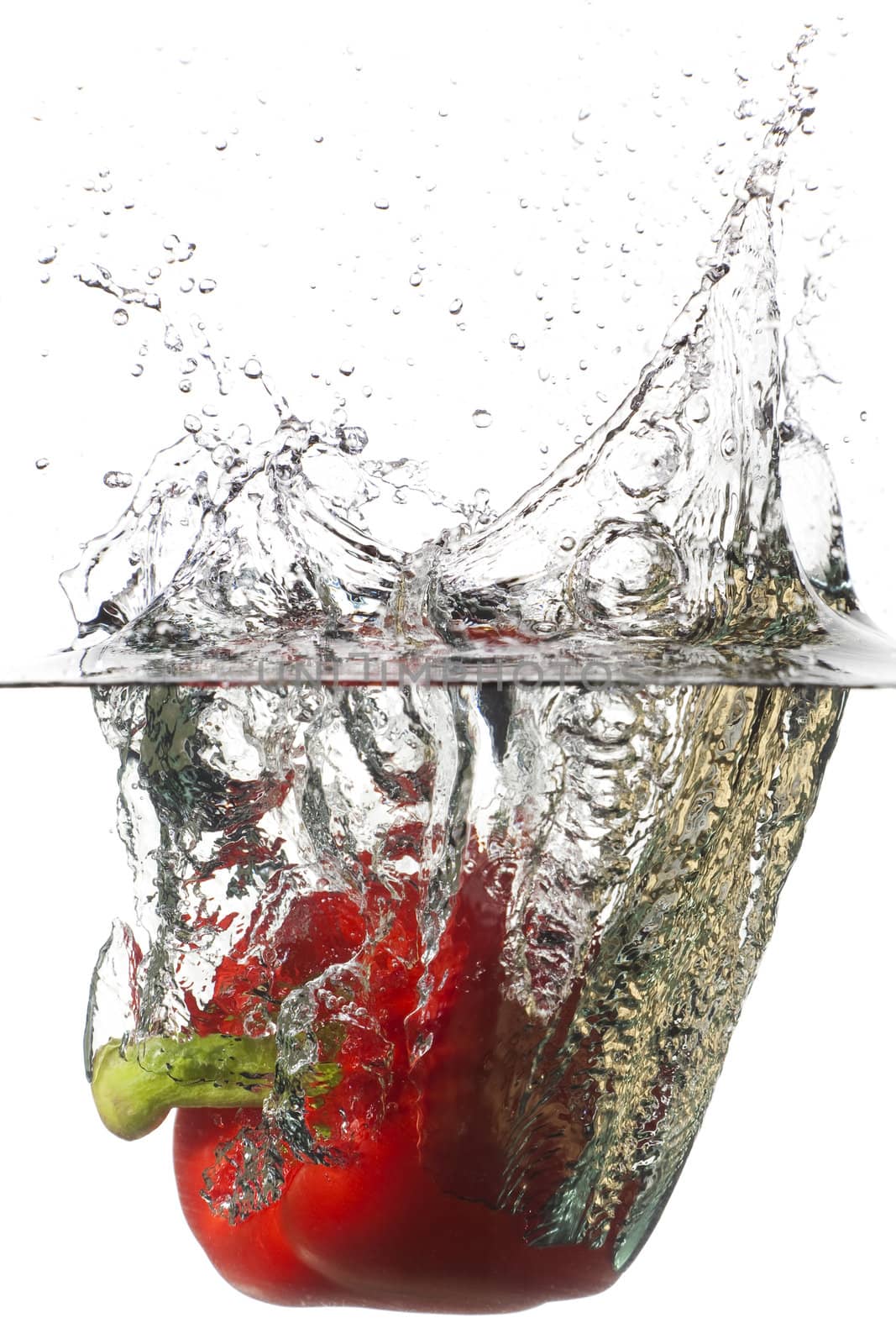 Red pepper falling in a water by Antartis