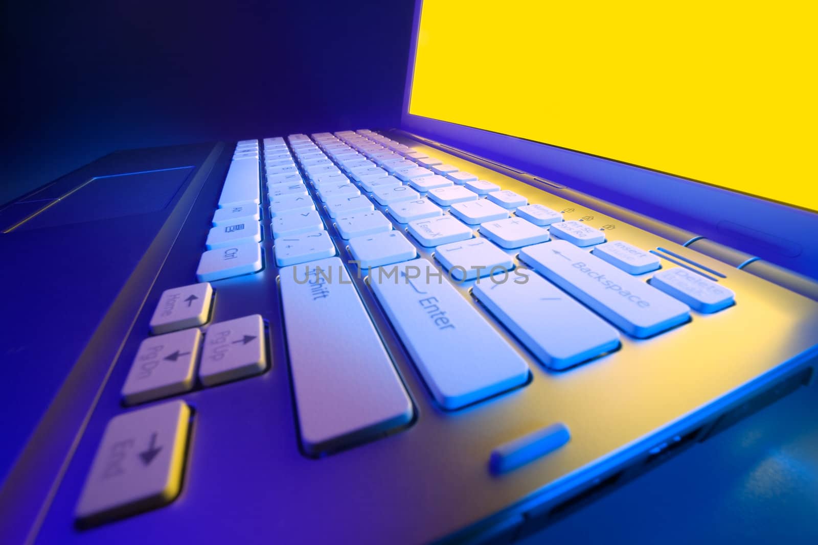 Modern laptop photographed at close range wide-angle lens with the effect of colored light