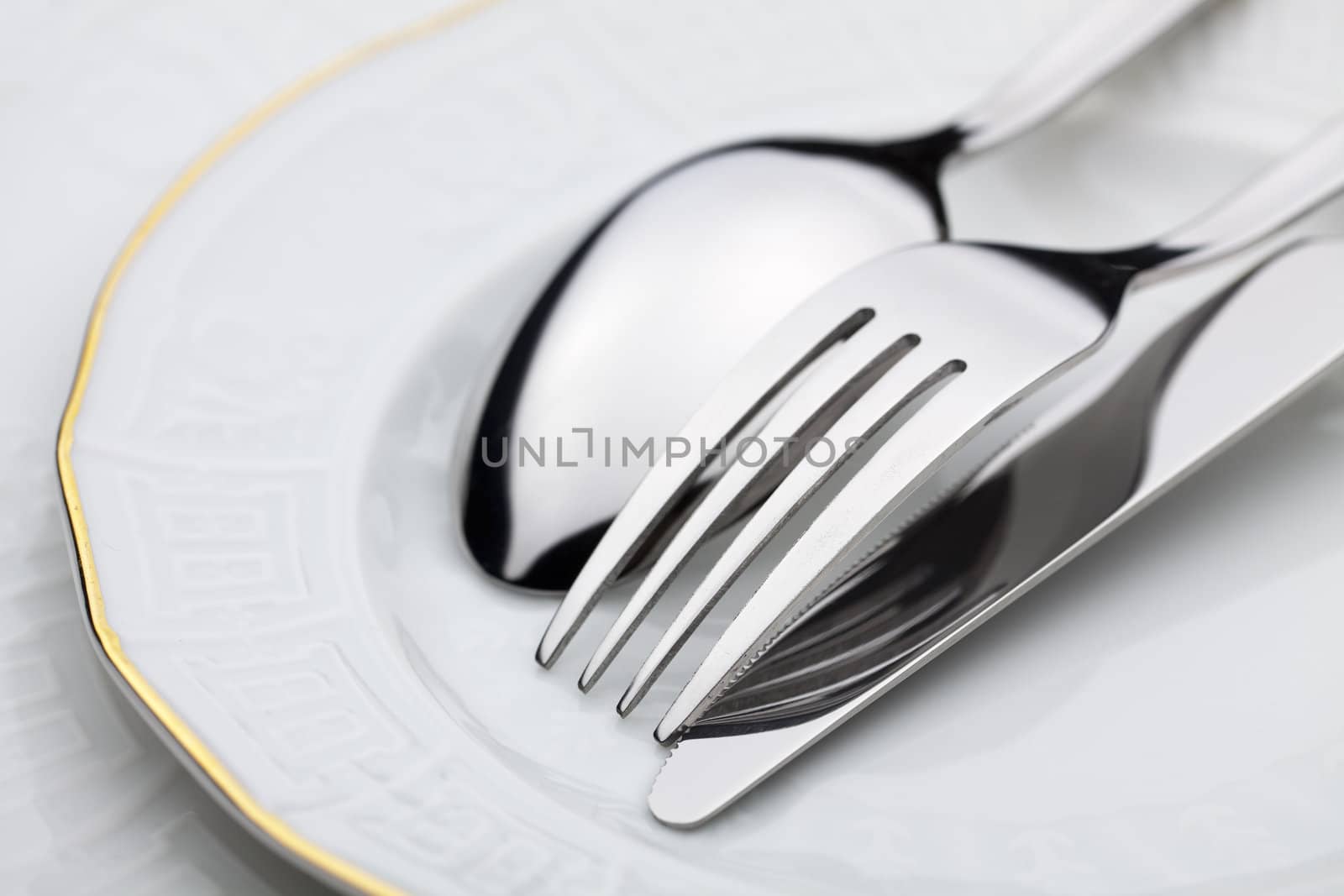 Knife, fork and spoon on a plate