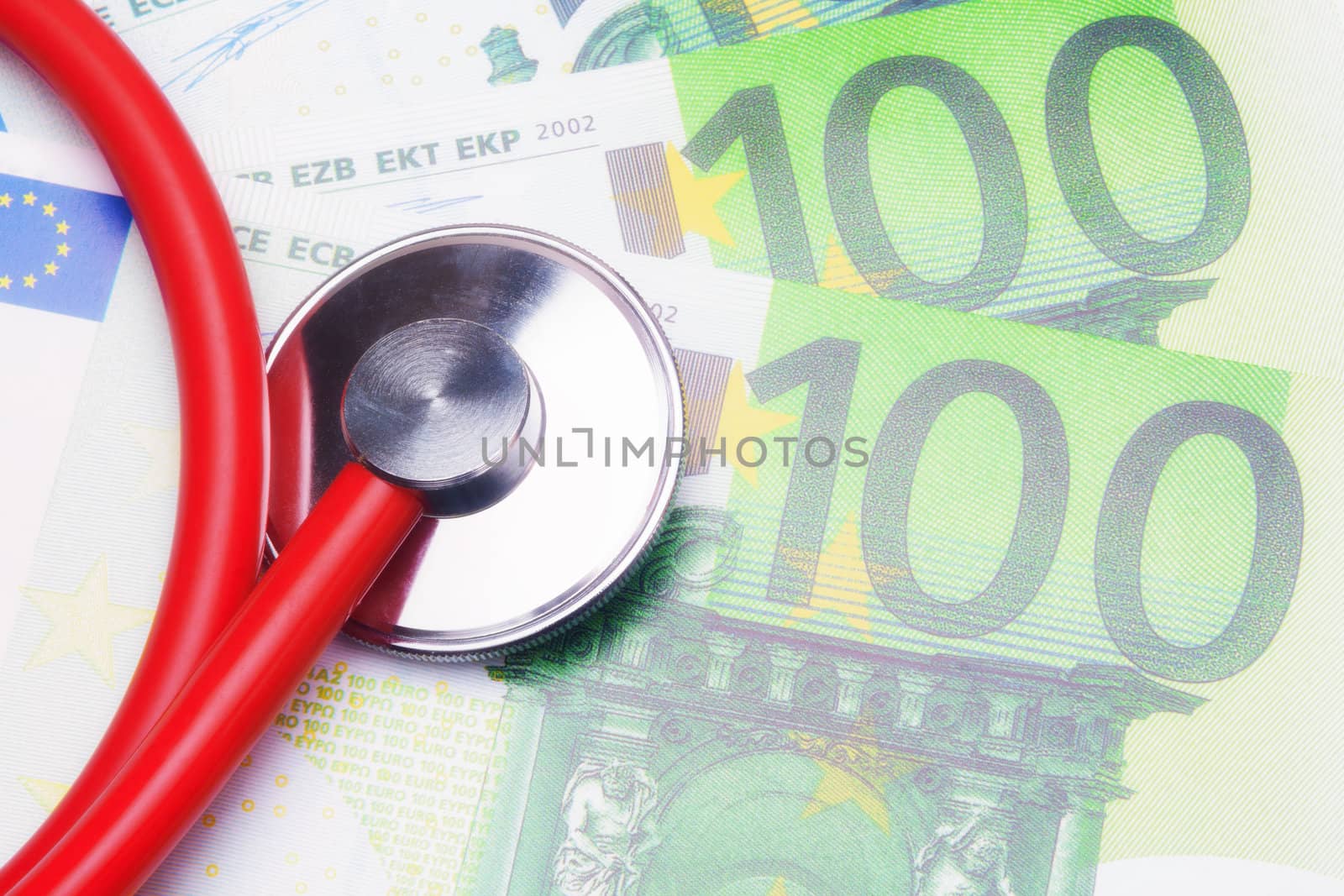 Red stethoscope close-up on top of Euro banknotes