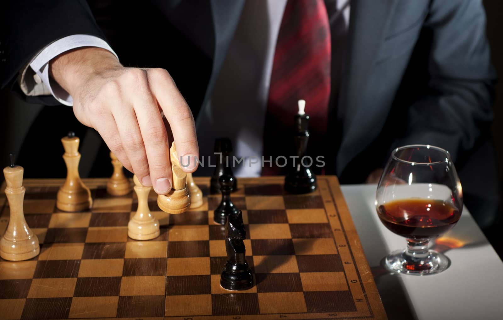 image of the businessman in a business suit plays chess