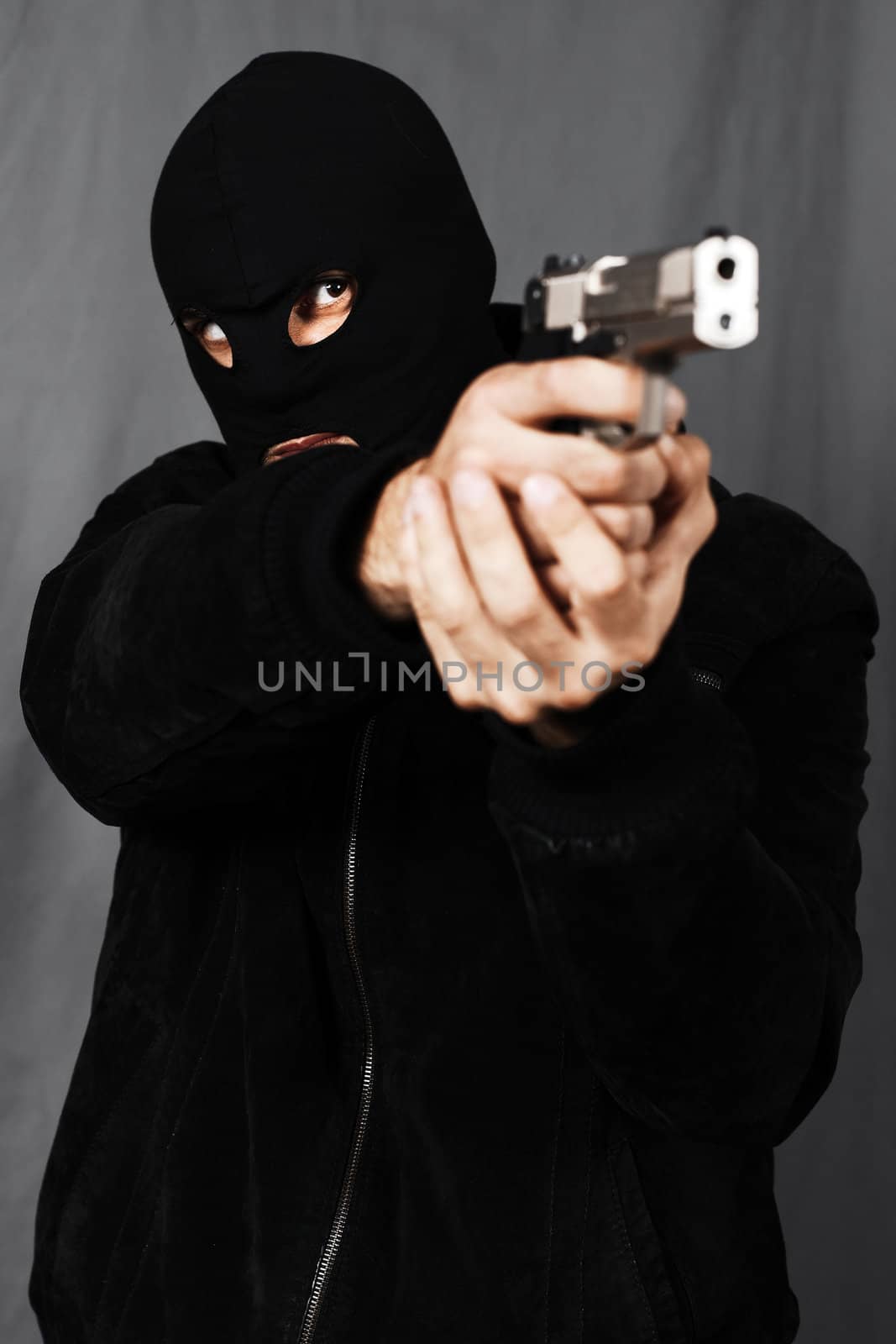 black dressed man and gun in studio