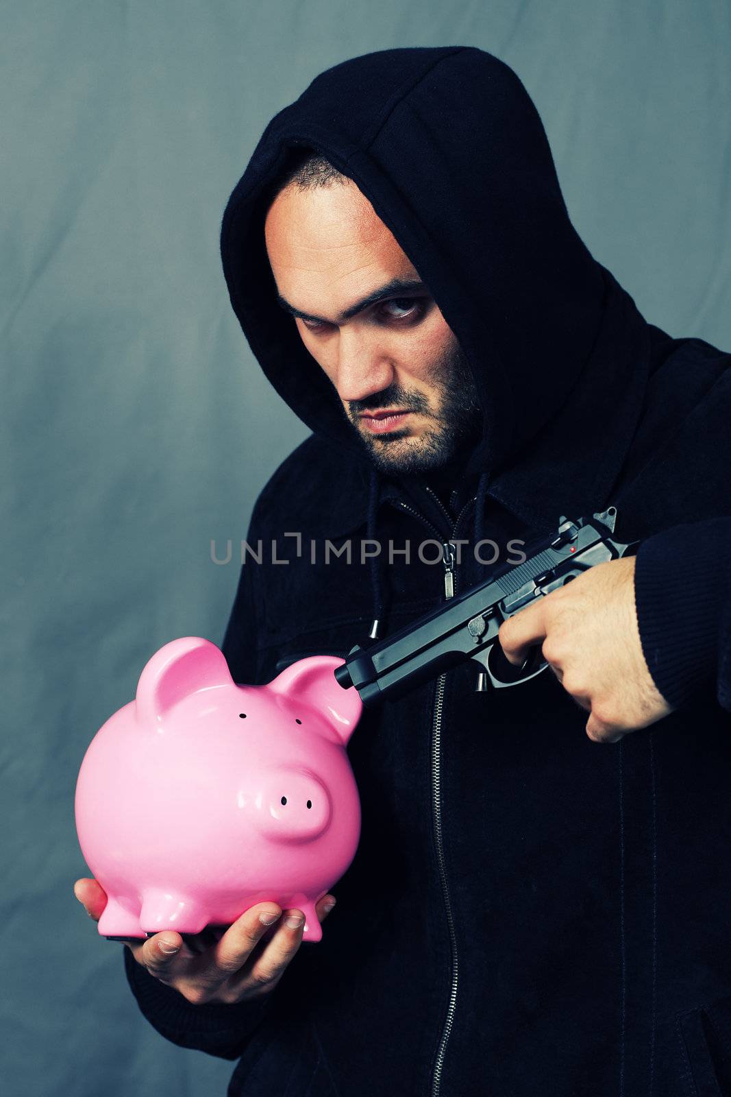 man with a gun and piggy bank with special photographic processing