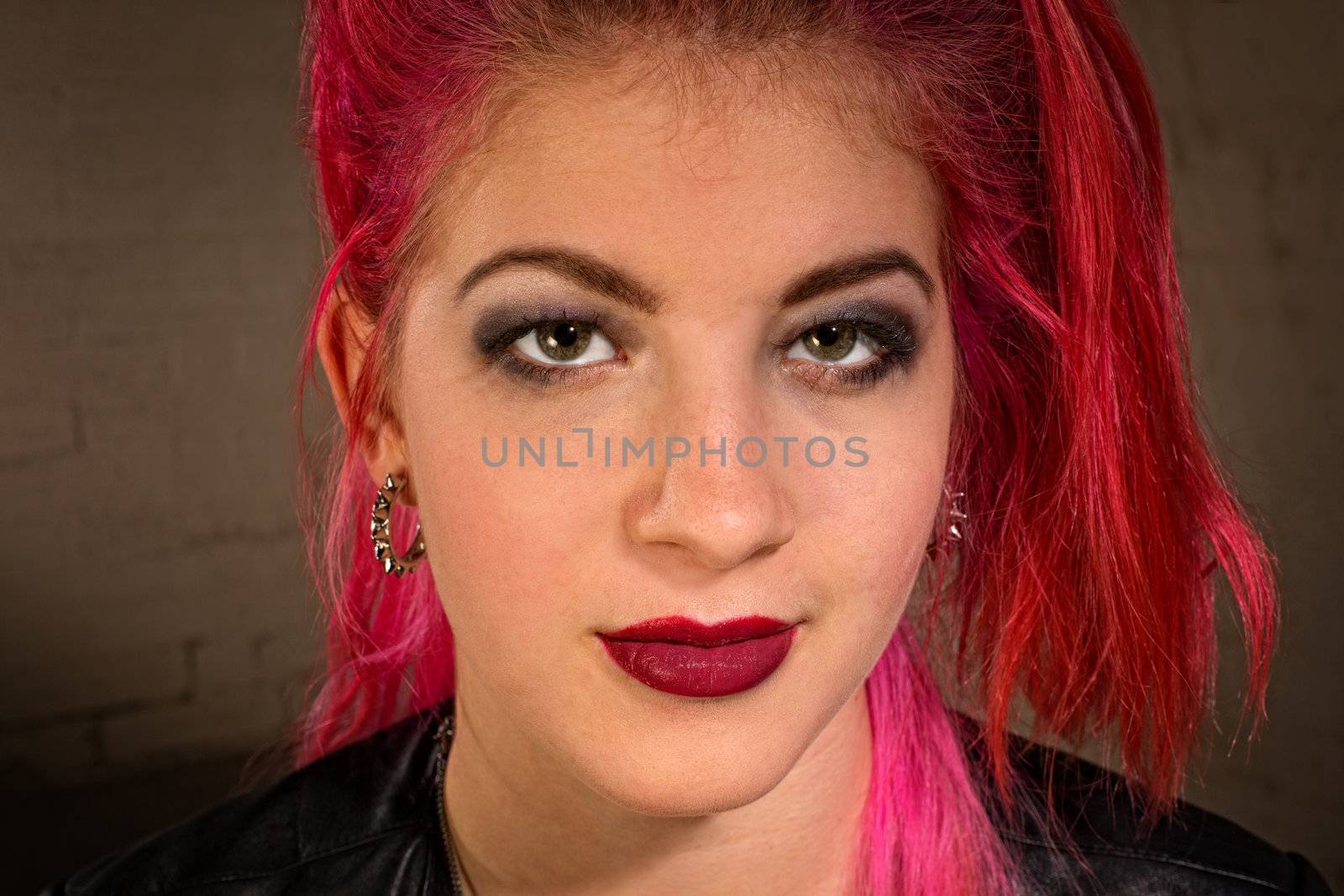 Confident young teen with pink and red hair