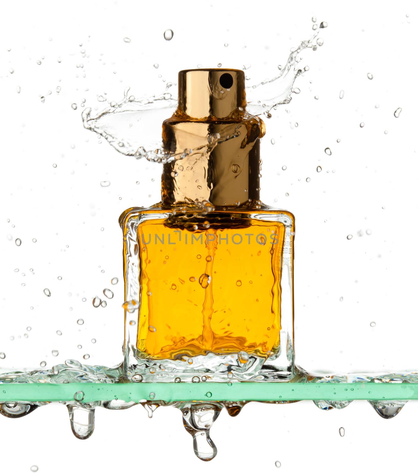 Small rectangular bottle of perfume all in a spray of water on a white background