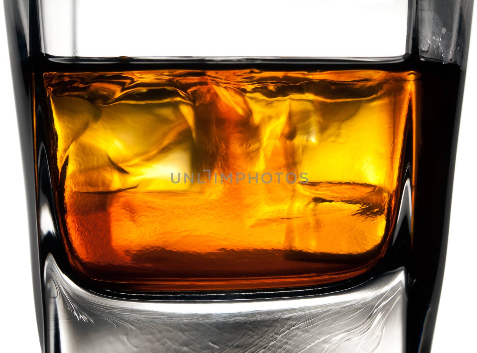 Glass of whiskey with ice cubes by Antartis