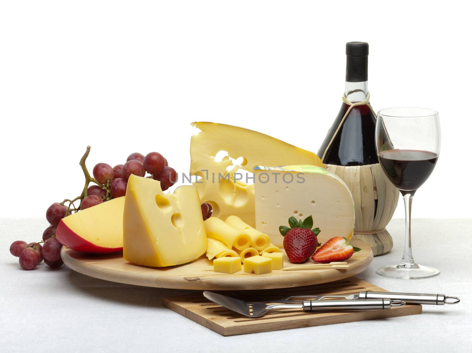 Cheese still life on a wooden round tray by Antartis
