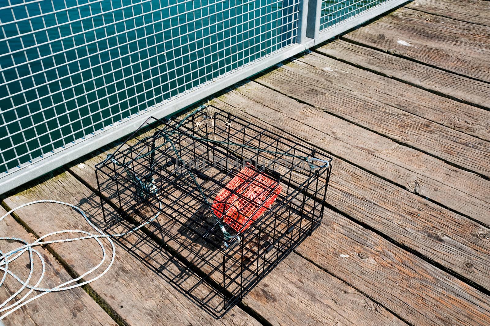 Empty crab pot on pier