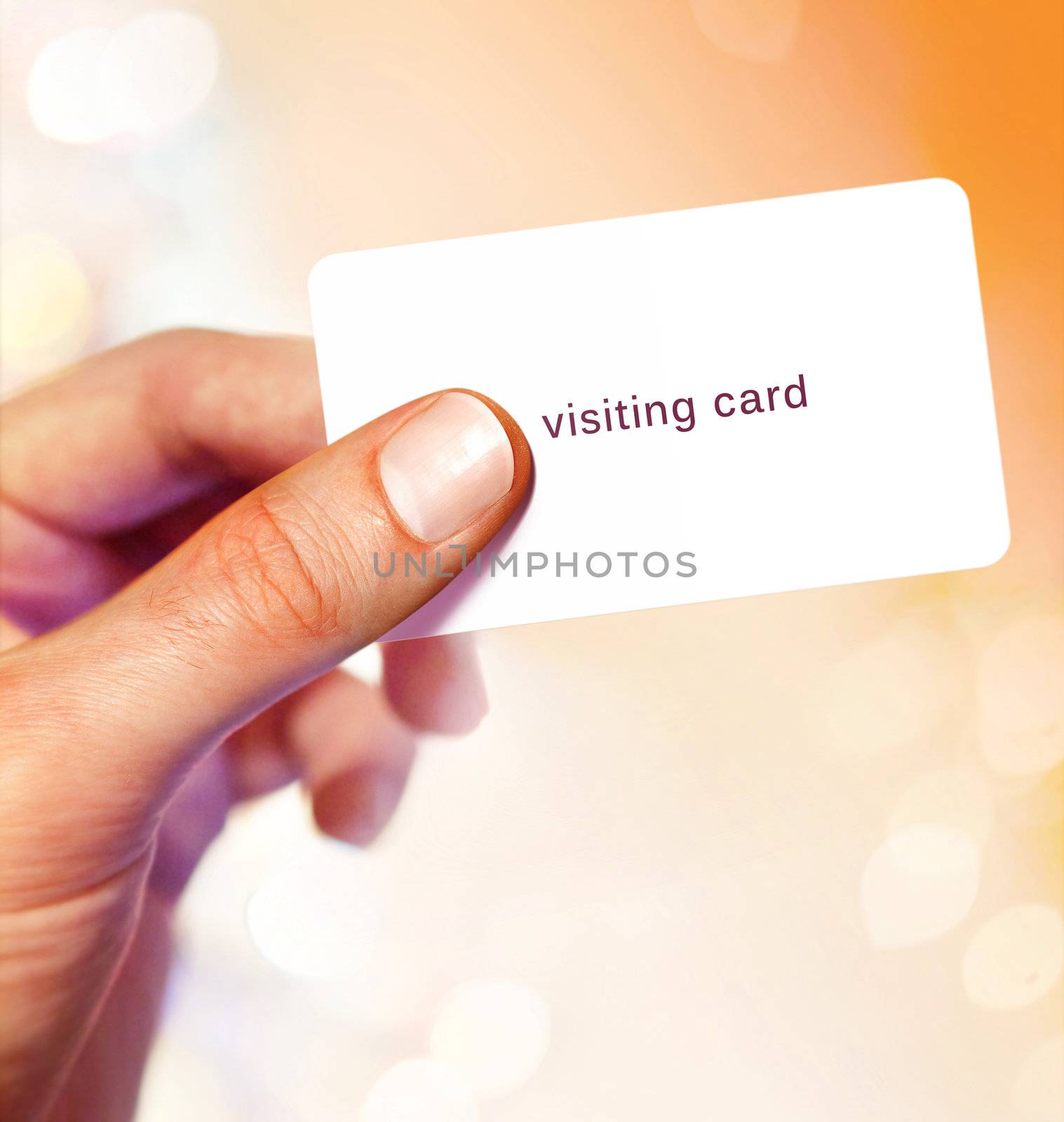 White visit card in hand on bright background