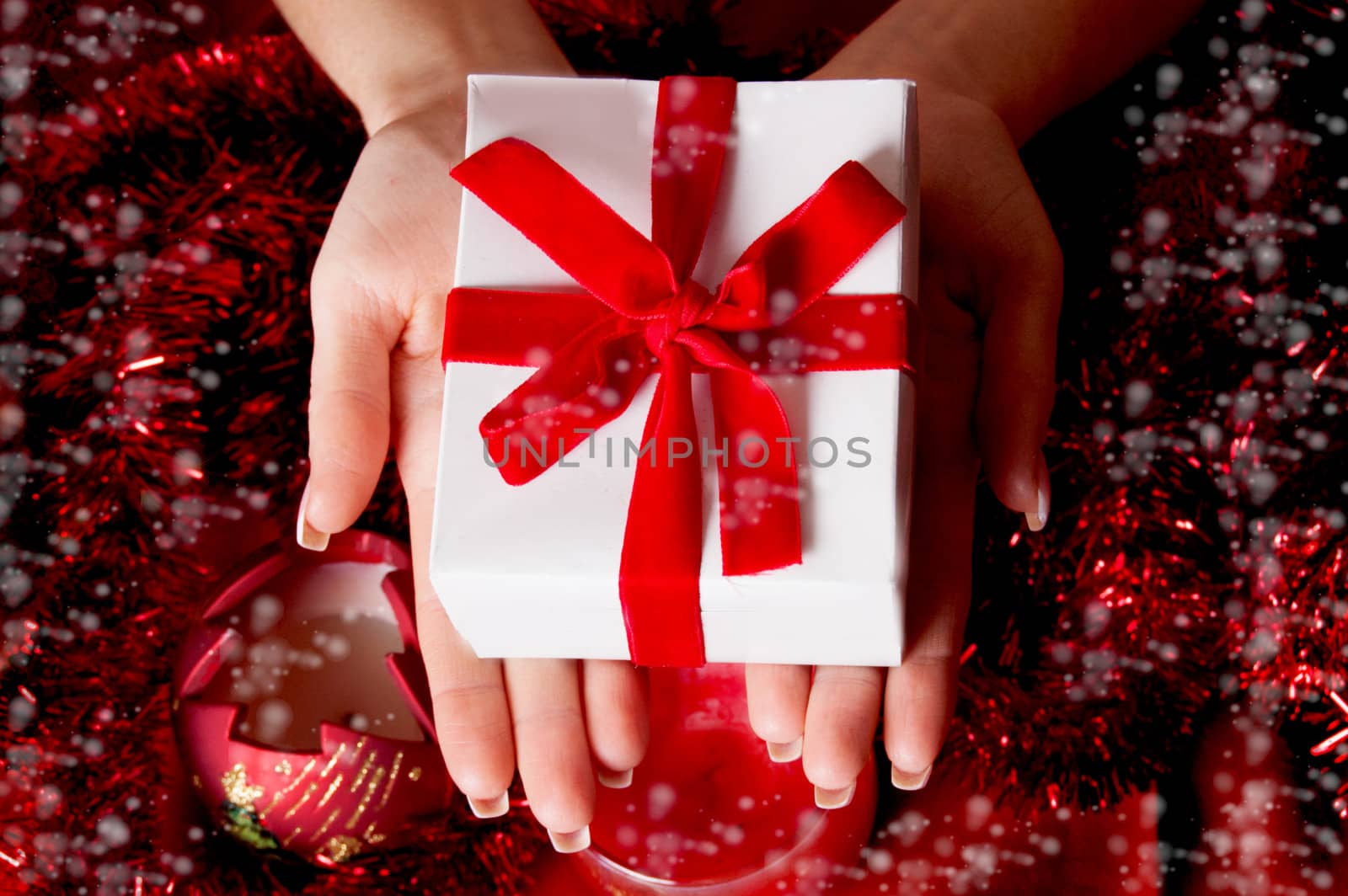 Woman hands holding red Christmas gift