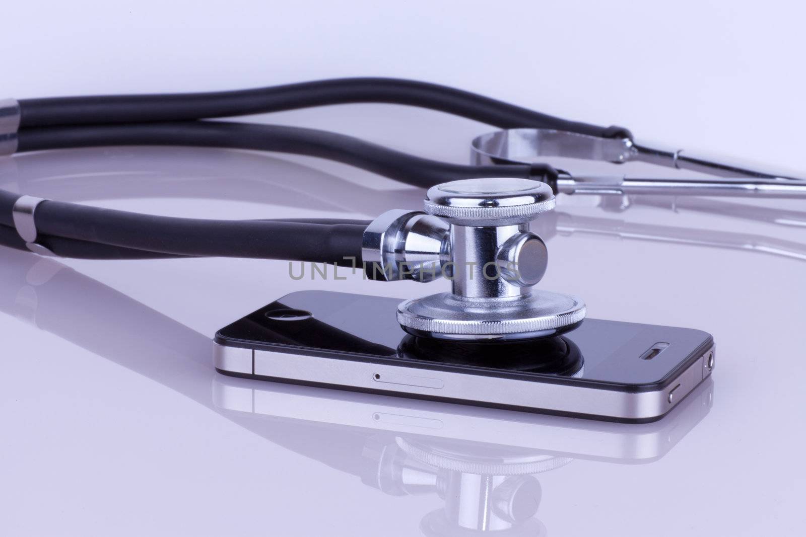 Stethoscope lying on the phone. Cell phone service