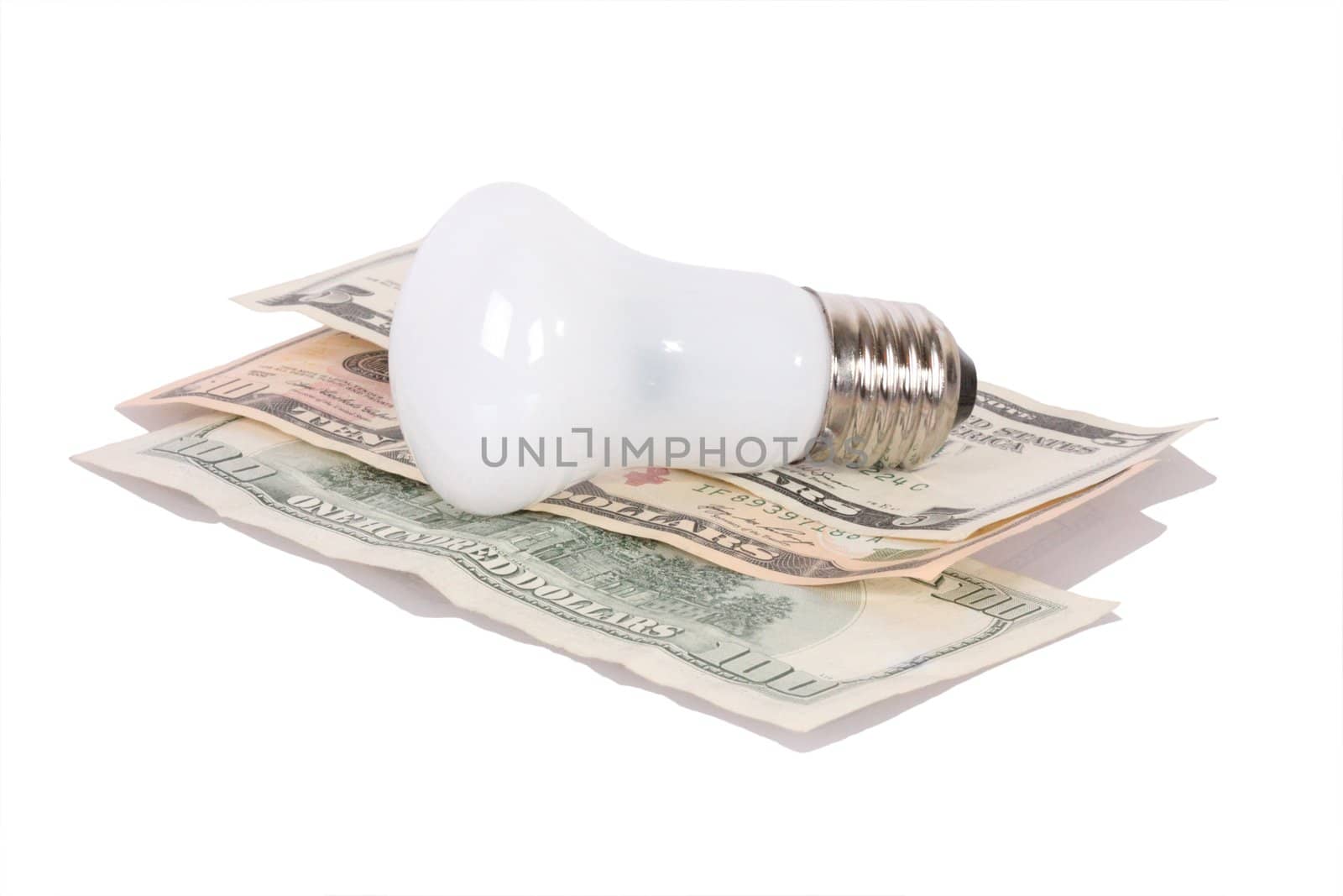 Old style bulb on dollars isolated on white