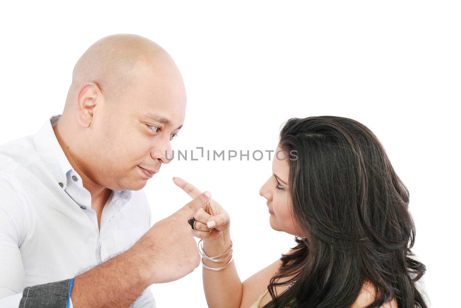 Young couple pointing at each other against a white background by dacasdo