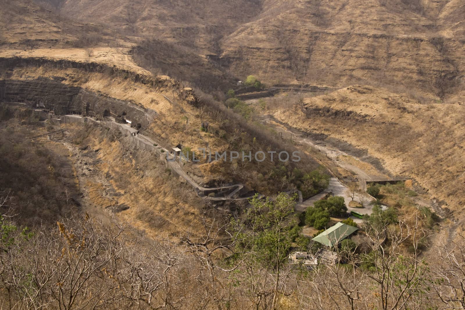 Horseshoe shaped river valley. Ancient rock temples and caves carved out of the cliff face. Ajanta Caves near Aurangabad, India. 1st Century BC to 6th Century AD.