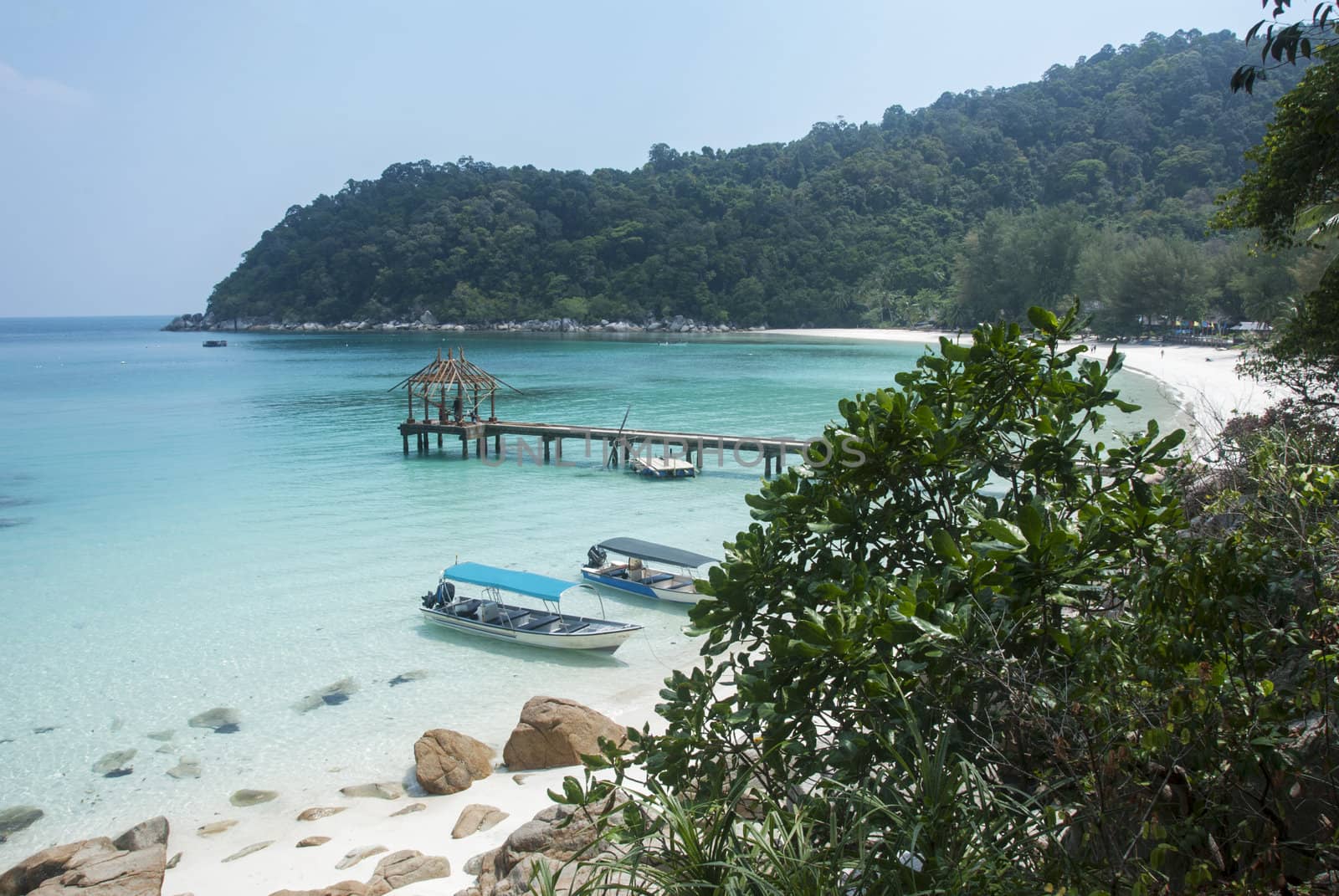 perhentian island beach with boats for transport