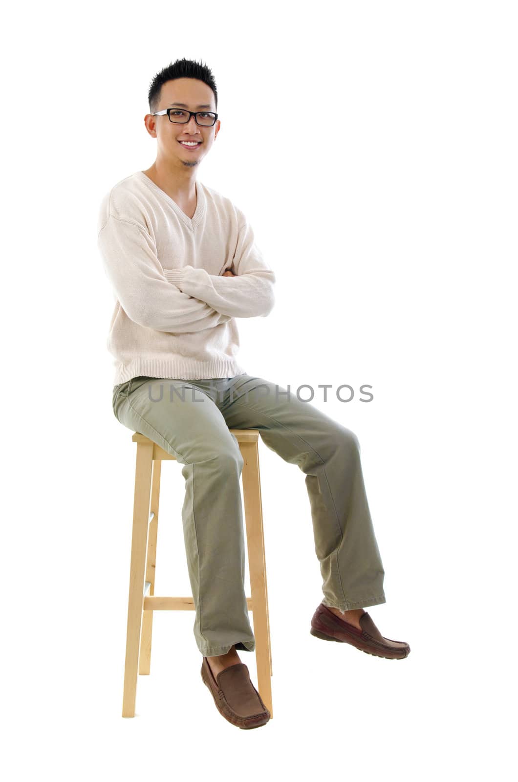 Full body Asian man sitting on a chair over white background