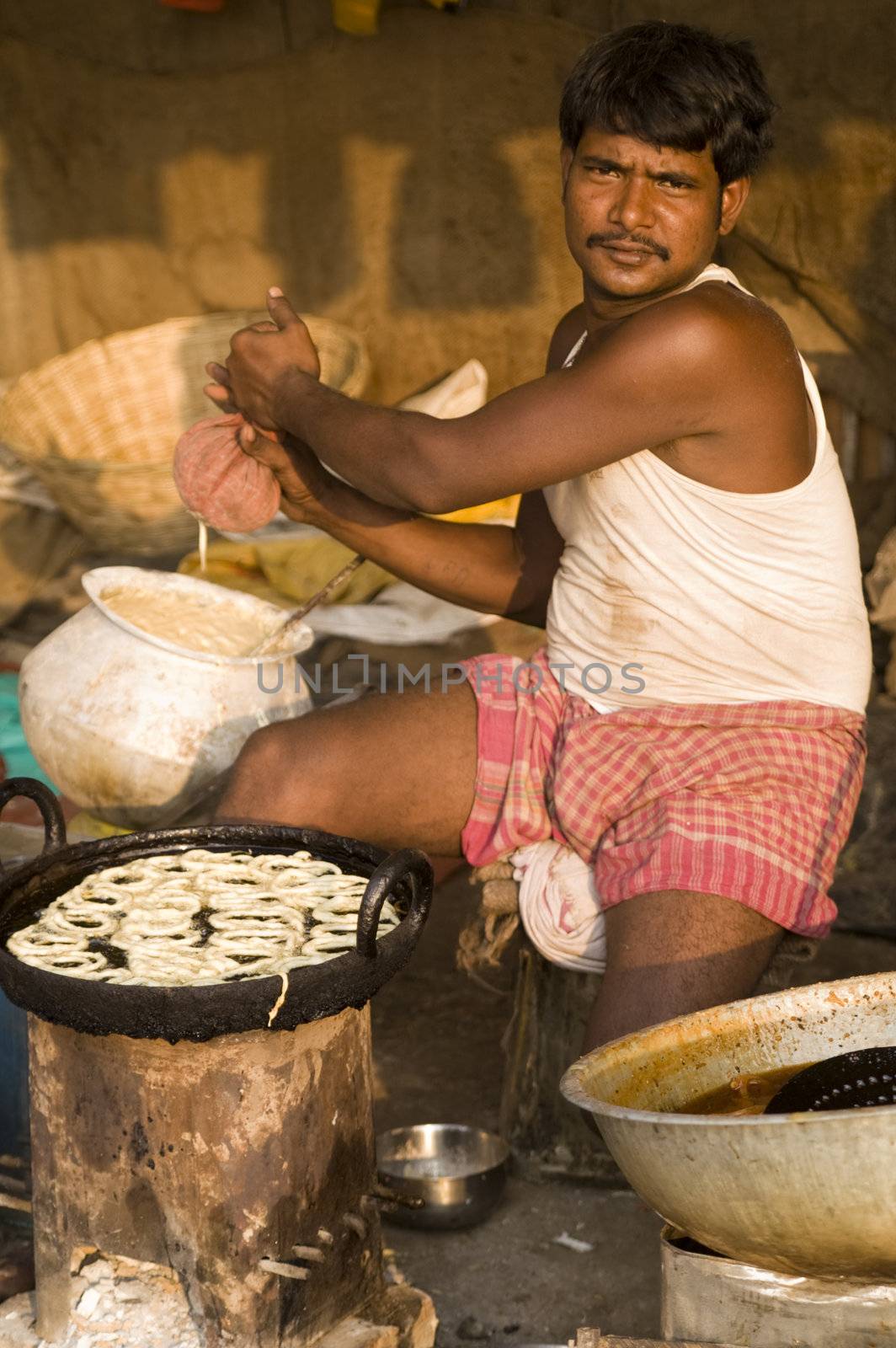 Indian street vendor preparing sweets for sale at the Sonepur livestock fair, India