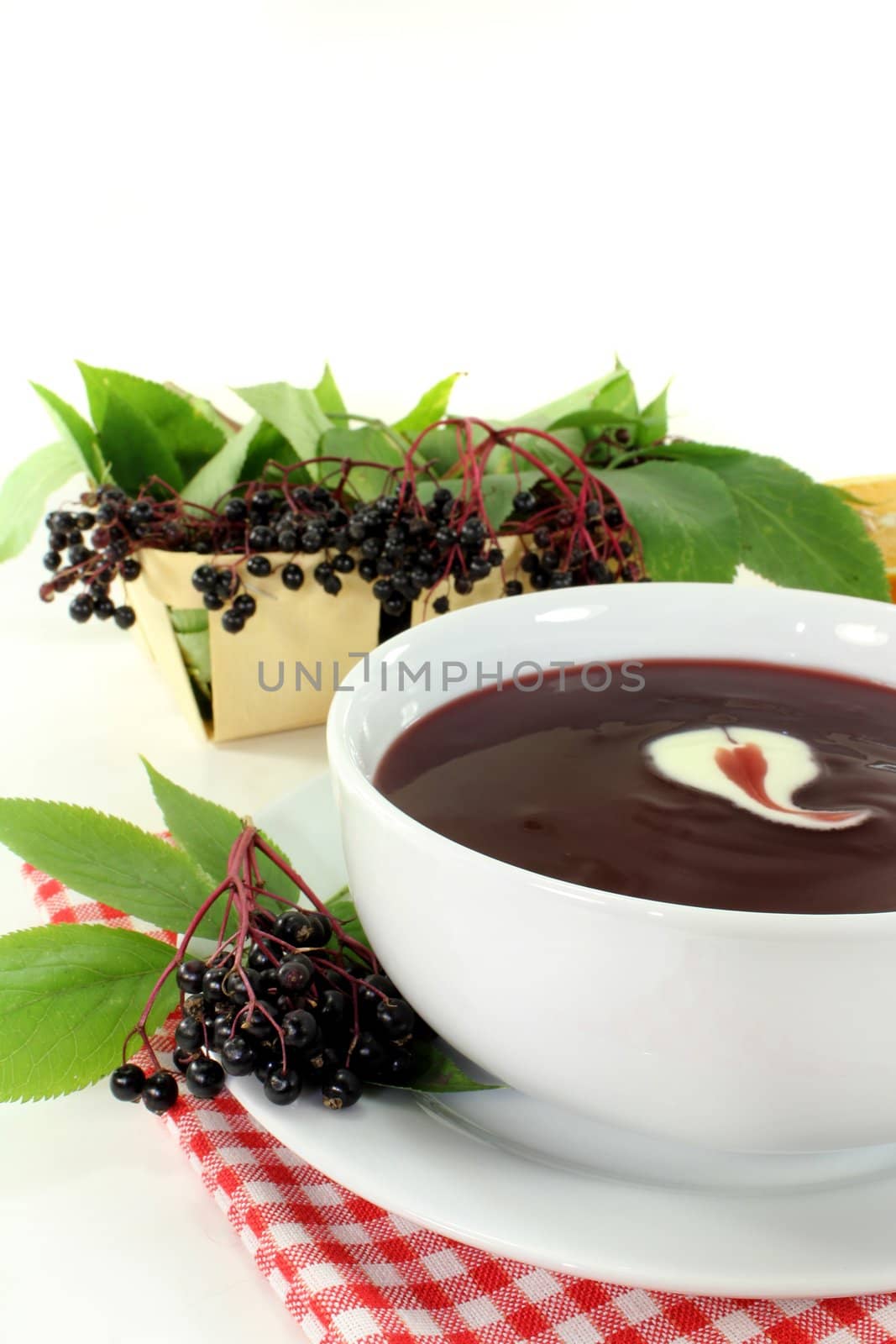 a bowl with Elderberry soup of fresh elderberries