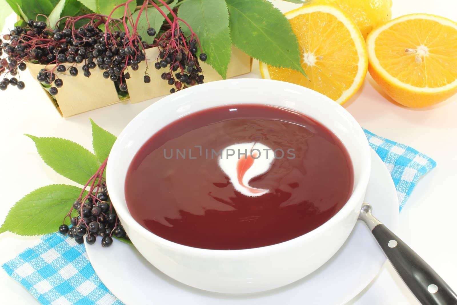 a bowl with Elderberry soup of fresh elderberries