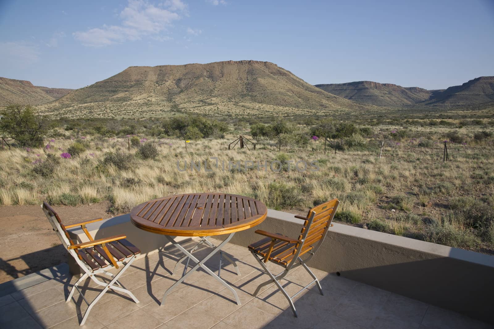 Rest camp in Karoo National Park in the Western Cape of South Africa. Table and chair on the veranda of a chalet.