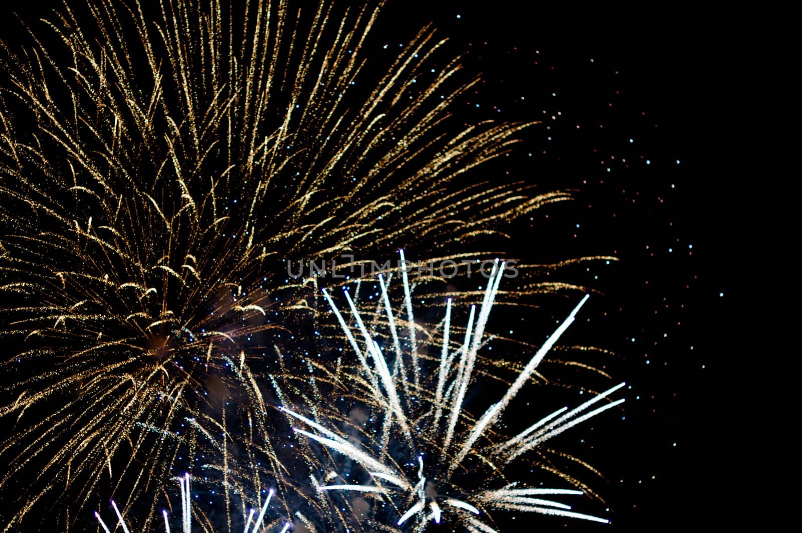 A delicate burst of fireworks in the night sky with room for your copy text (happy new year)