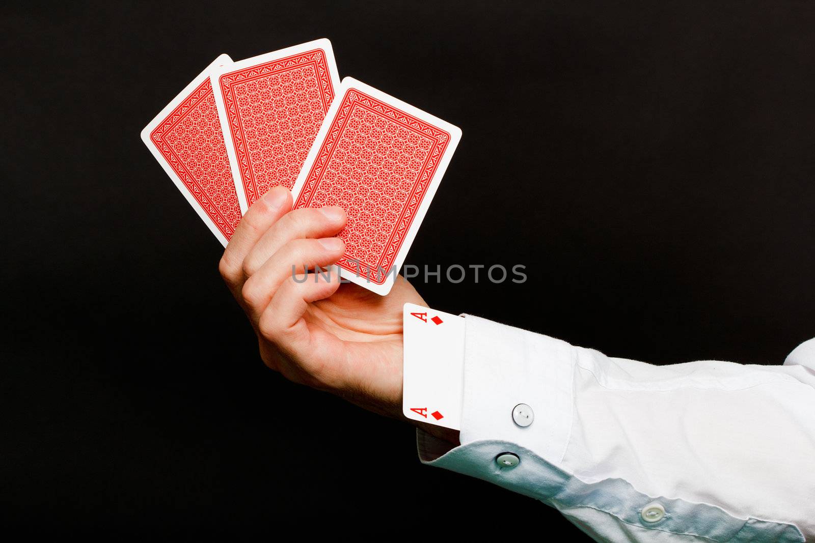 playing cards and an ace in the hole on a black background