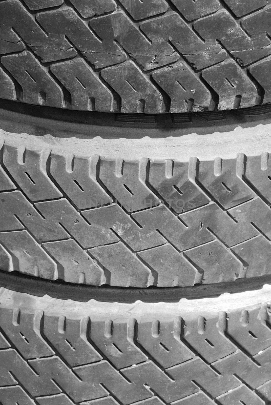 Three old tyres on a one stack - background