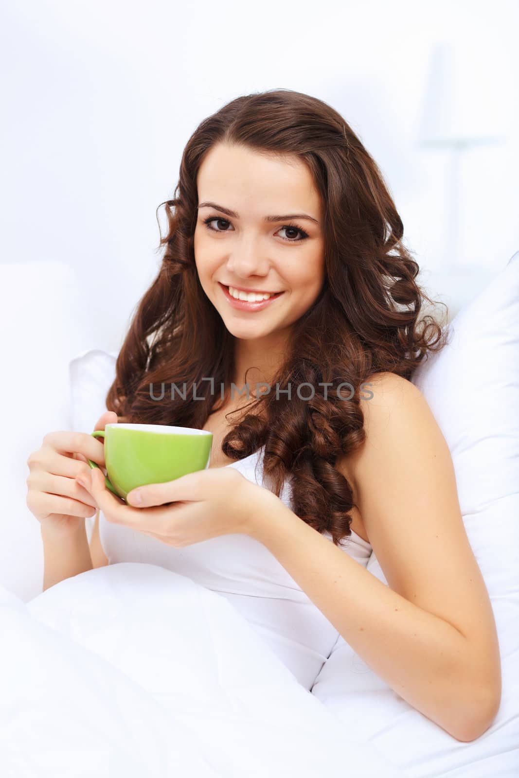 Portrait of lovely young woman having cup of tea at home