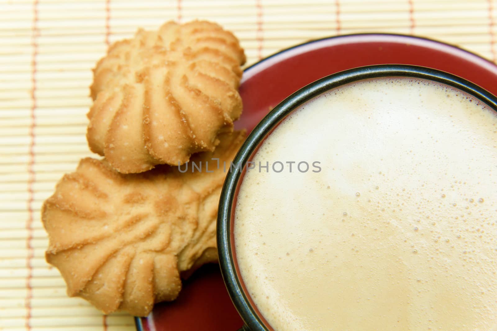 cup of coffee and cookies on a background mat