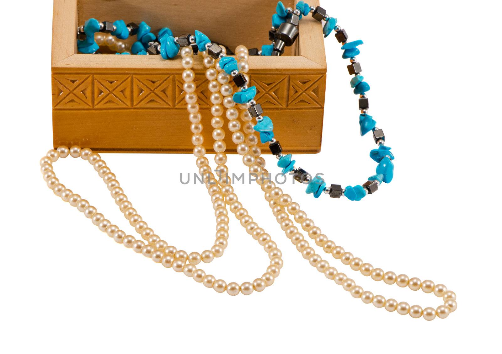 Wooden box with pearl and blue stone necklaces isolated on white