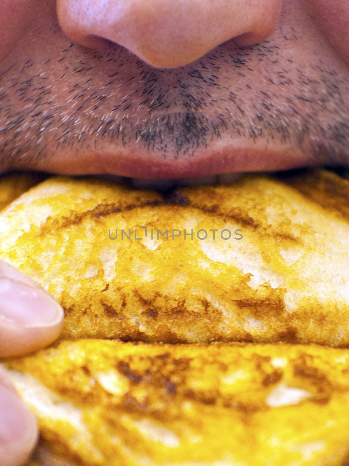 Man biting a piece of toast close up